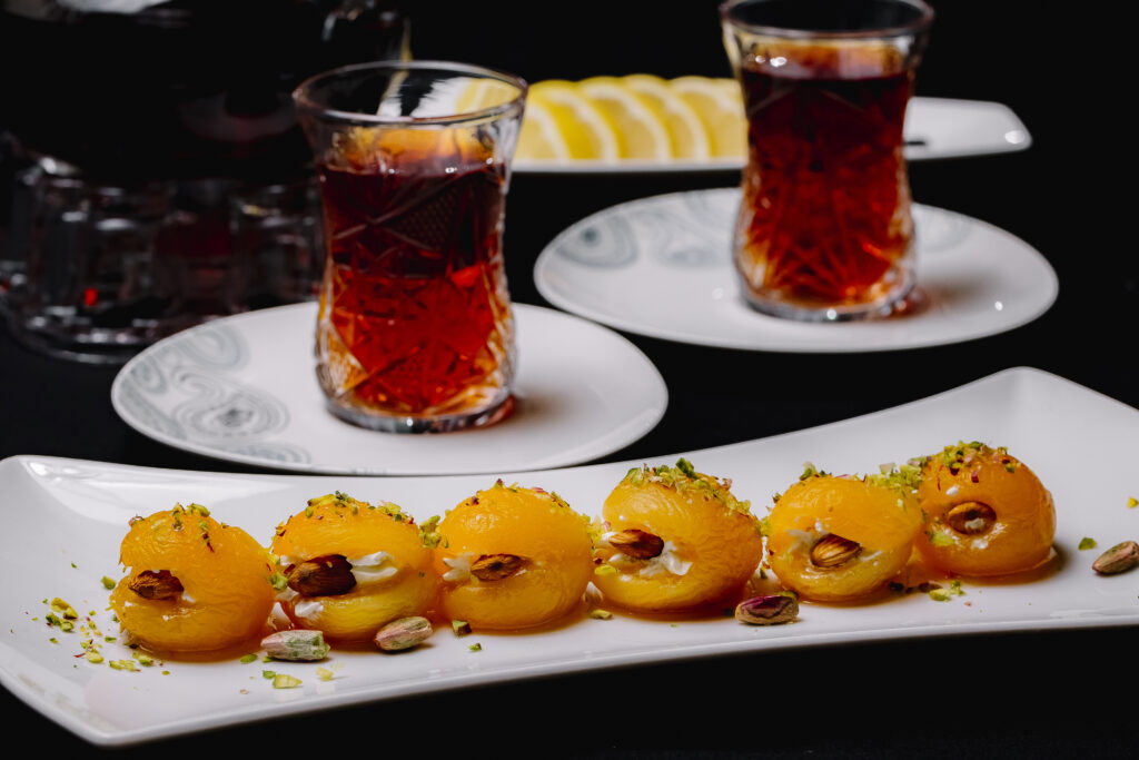 dry apricot with almond pistachios cream inside tea in armudy lemon side view